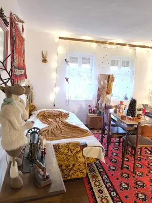 a bedroom with a bed and a desk and a table at Vila Kruna in Pirot