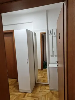 a room with white walls and a hallway with a mirror at Apartman BN in Vrnjačka Banja