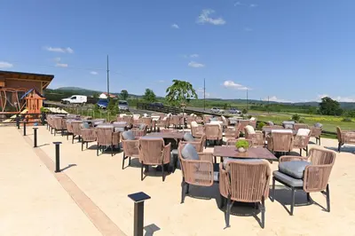a row of tables and chairs on a patio at Horizonti in Vrmdža