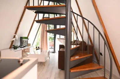a spiral staircase in a house with a living room at Horizonti in Vrmdža
