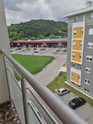 a balcony with a view of a parking lot at Apartman Zapadni Kej Pirot in Pirot