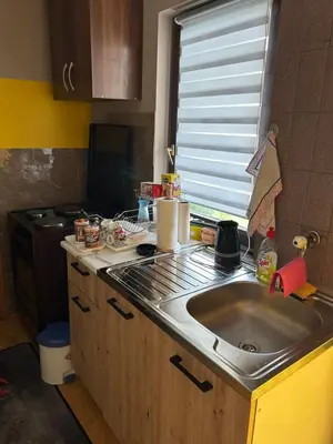 a kitchen counter with a sink and a window at Vanila in Leskovac