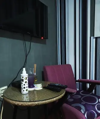 a table with a remote control and a television on it at Vanila in Leskovac