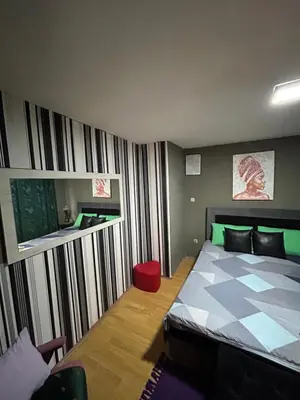 a bedroom with a bed with a checkerboard pattern at Vanila in Leskovac