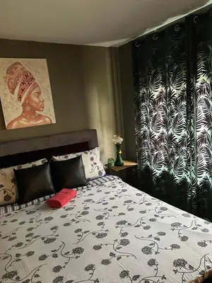 a bedroom with a bed with a black and white blanket at Vanila in Leskovac