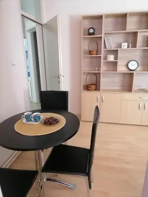 a dining room with a table and two chairs at Apartman Jabuka in Paraćin