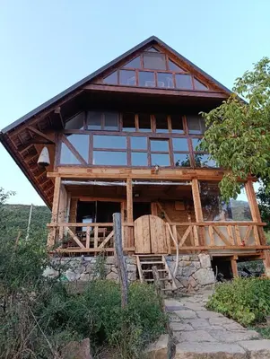 a large wooden house with a large window at Magarija 1 in Dimitrovgrad