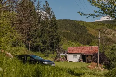 a car parked in front of a small house at Kuca Lula Stara planina in Pirot