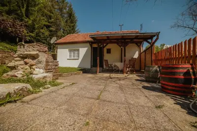 a small white house with a wooden pergola at Kuca Lula Stara planina in Pirot