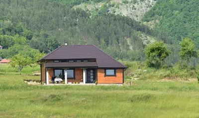 a small wooden cabin in a field of grass at Kucica od drveta 1 in Kopaonik