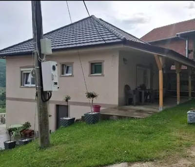 a small house with a porch and a house at Apartman Nikolić in Kuršumlija