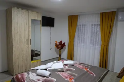 a bedroom with a bed with towels on it at Apartman Nikolić in Kuršumlija