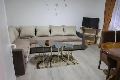 a living room with a couch and two tables at Apartman Nikolić in Kuršumlija