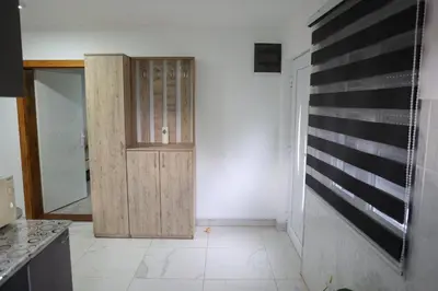 a kitchen with a wooden door in a room at Apartman Nikolić in Kuršumlija