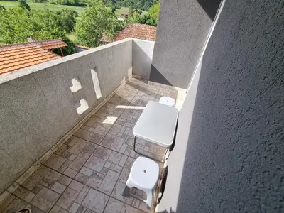 a bathroom with two toilets on the side of a wall at Vila MINJA in Soko Banja
