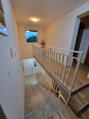a winding staircase in a house with a window at Vila MINJA in Soko Banja