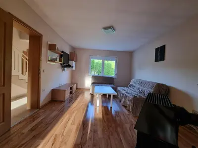 a living room with a couch and a table at Vila MINJA in Soko Banja