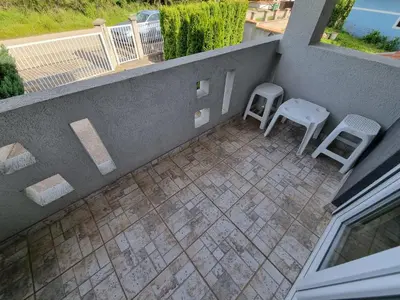 an outdoor patio with two chairs and a table at Vila MINJA in Soko Banja