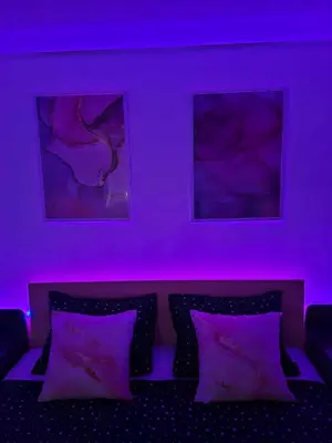 a purple room with a bed with purple lighting at MAGNIV Home in Vranje