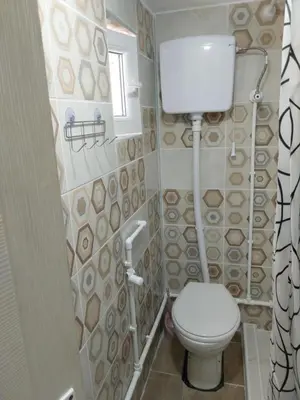 a small bathroom with a toilet and a window at MAGNIV Home in Vranje