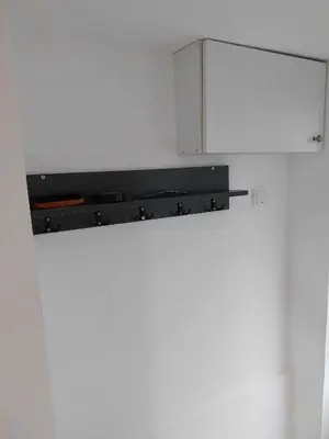a kitchen with a white refrigerator with a cabinet at MAGNIV Home in Vranje