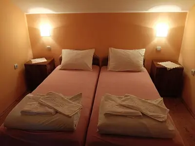 a bedroom with two beds with towels on them at Apartmani Petrović in Soko Banja