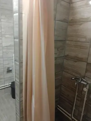 a shower with a shower curtain in a bathroom at Apartmani Petrović in Soko Banja
