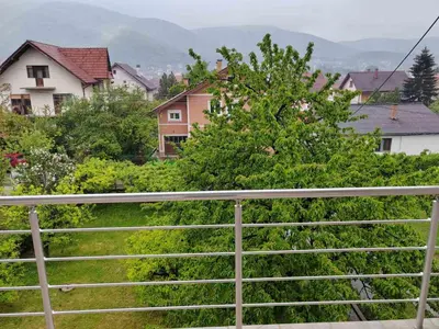 a view of a yard with a fence and houses at Apartmani Petrović in Soko Banja
