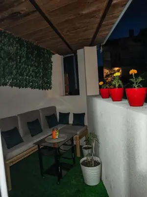 a patio with a couch and a table and potted plants at Studio D&I in Vranje