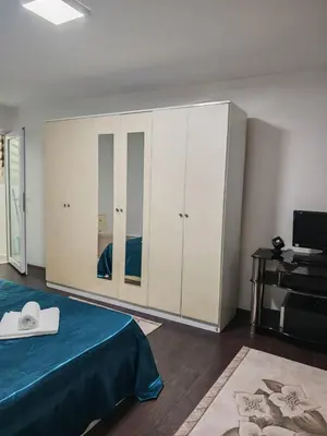 a bedroom with a bed and a tv and a room with at Studio D&I in Vranje