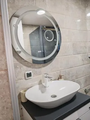 a bathroom with a white sink and a mirror at Studio D&I in Vranje