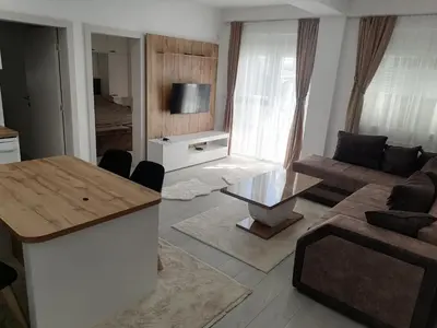 a living room with a couch and a table at Apartman Jelena in Vranje