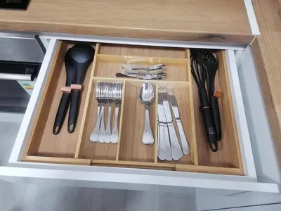 a drawer with utensils in a cabinet at Apartman Jelena in Vranje