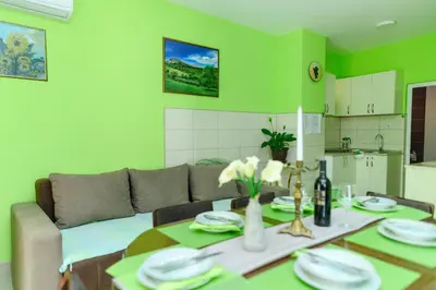 a living room with a table and a couch at Vila Misljenovic, u centru Sokobanje, na pesackoj zoni in Soko Banja