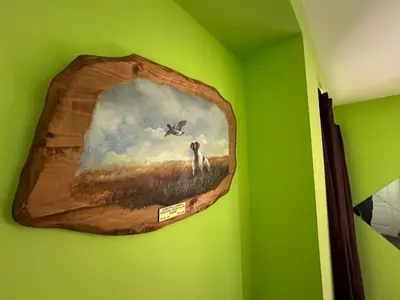 a painting of a dog on a green wall at Vila Misljenovic, u centru Sokobanje, na pesackoj zoni in Soko Banja