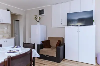 a living room with a table and a chair at Vila Misljenovic, u centru Sokobanje, na pesackoj zoni in Soko Banja