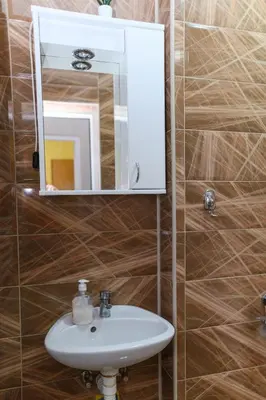 a bathroom with a sink and a mirror at Vila Misljenovic, u centru Sokobanje, na pesackoj zoni in Soko Banja