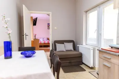 a living room with a table and a chair at Vila Misljenovic, u centru Sokobanje, na pesackoj zoni in Soko Banja