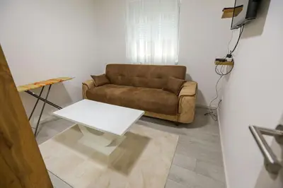 a living room with a couch and a table at Apartman Jelena in Vranje