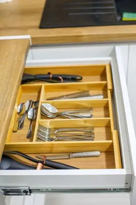 a drawer in a cabinet filled with utensils at Apartman Jelena in Vranje