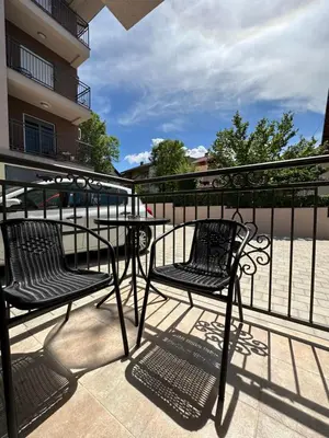 two chairs and a table on a balcony at Talija apartman 4 in Vrnjačka Banja