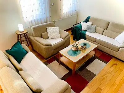 a living room with two couches and a coffee table at Apartman Family in Vrnjačka Banja