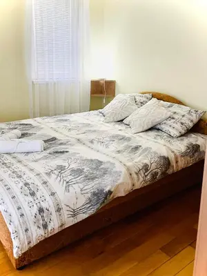 an unmade bed in a bedroom with a window at Apartman Family in Vrnjačka Banja