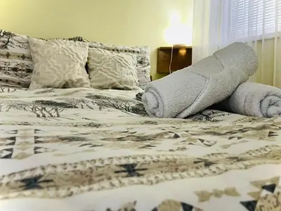 a bed with a cast on the end of it at Apartman Family in Vrnjačka Banja