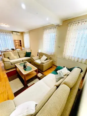 a living room with two couches and a table at Apartman Family in Vrnjačka Banja