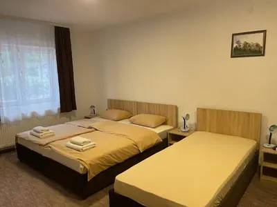 a bedroom with two beds and a window at 4 vodenice Brzeće B&B in Brzeće