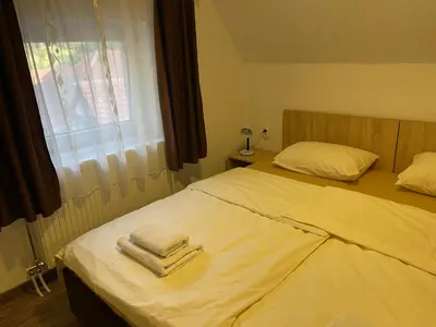 a bedroom with two beds with towels on them at 4 vodenice Brzeće B&B in Brzeće