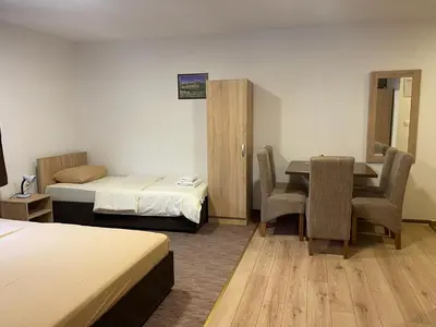 a hotel room with a bed and a table and chairs at 4 vodenice Brzeće B&B in Brzeće