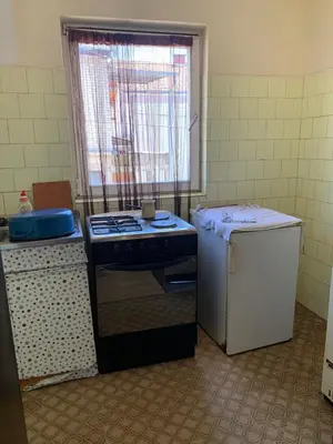 a kitchen with a stove and a small refrigerator at Kuca u Prokuplju in Prokuplje