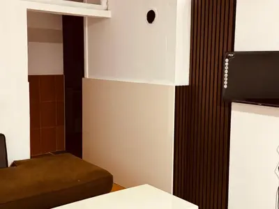 a small room with a bed and a tv at Jelena in Vranje